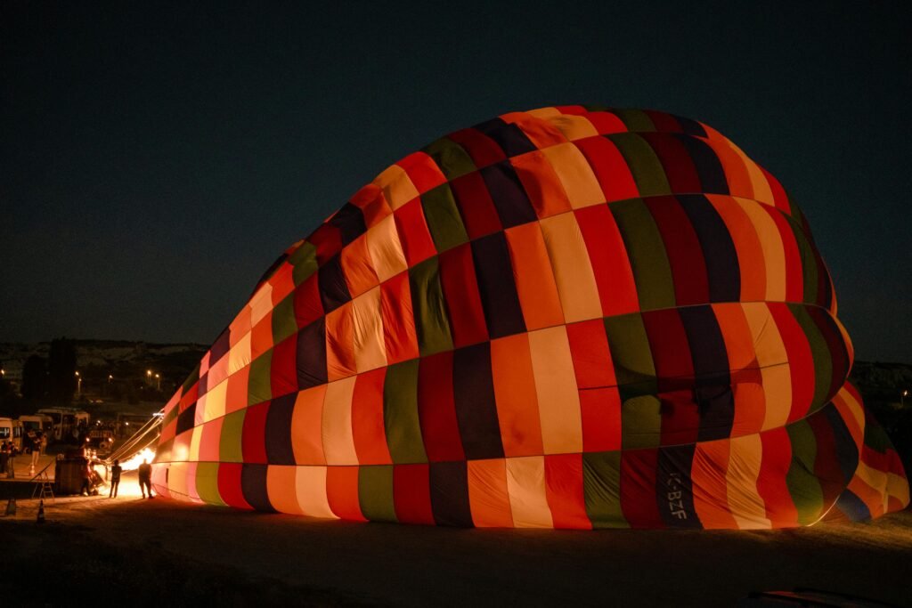 A colorful hot air balloon being inflated for an exciting adventure under the night sky.